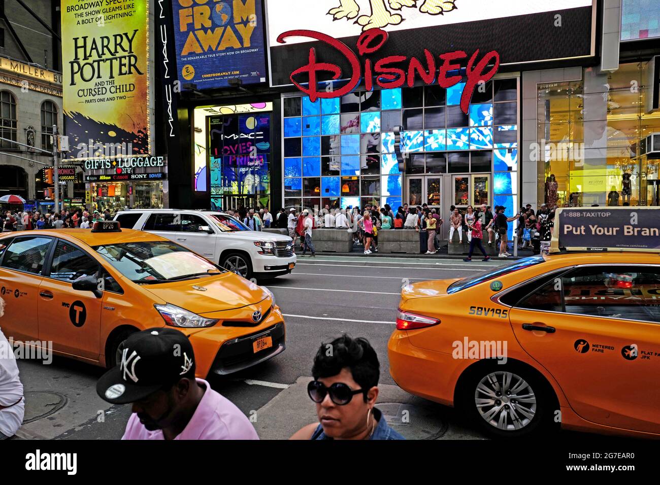 Disney store and yellow cabs at Times Square in Manhattan, in New York City. Stock Photo