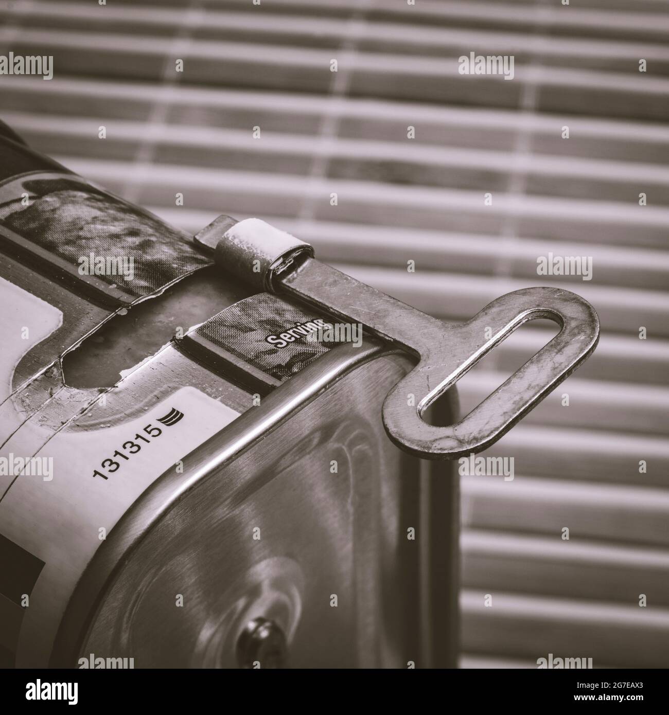Monochrome twistkey tin opener / canopener on an ASDA luncheon meat tinned product. Concept