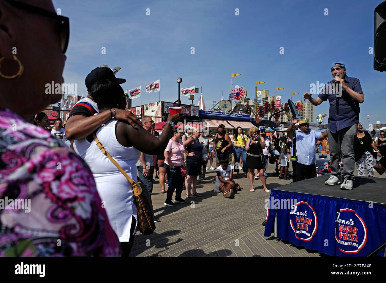 Karaoke singer on Coney Island boardwalk, during an hot summer's sunday afternoon, in New York City. Stock Photo