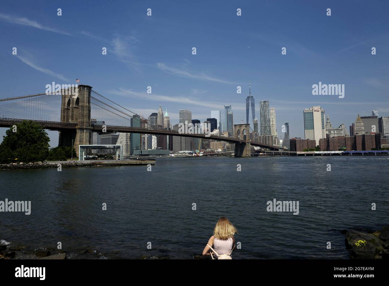 walk lane and bike lane on Brooklyn bridge, with blue sky over Manhattan skyline, in New York City. Stock Photo