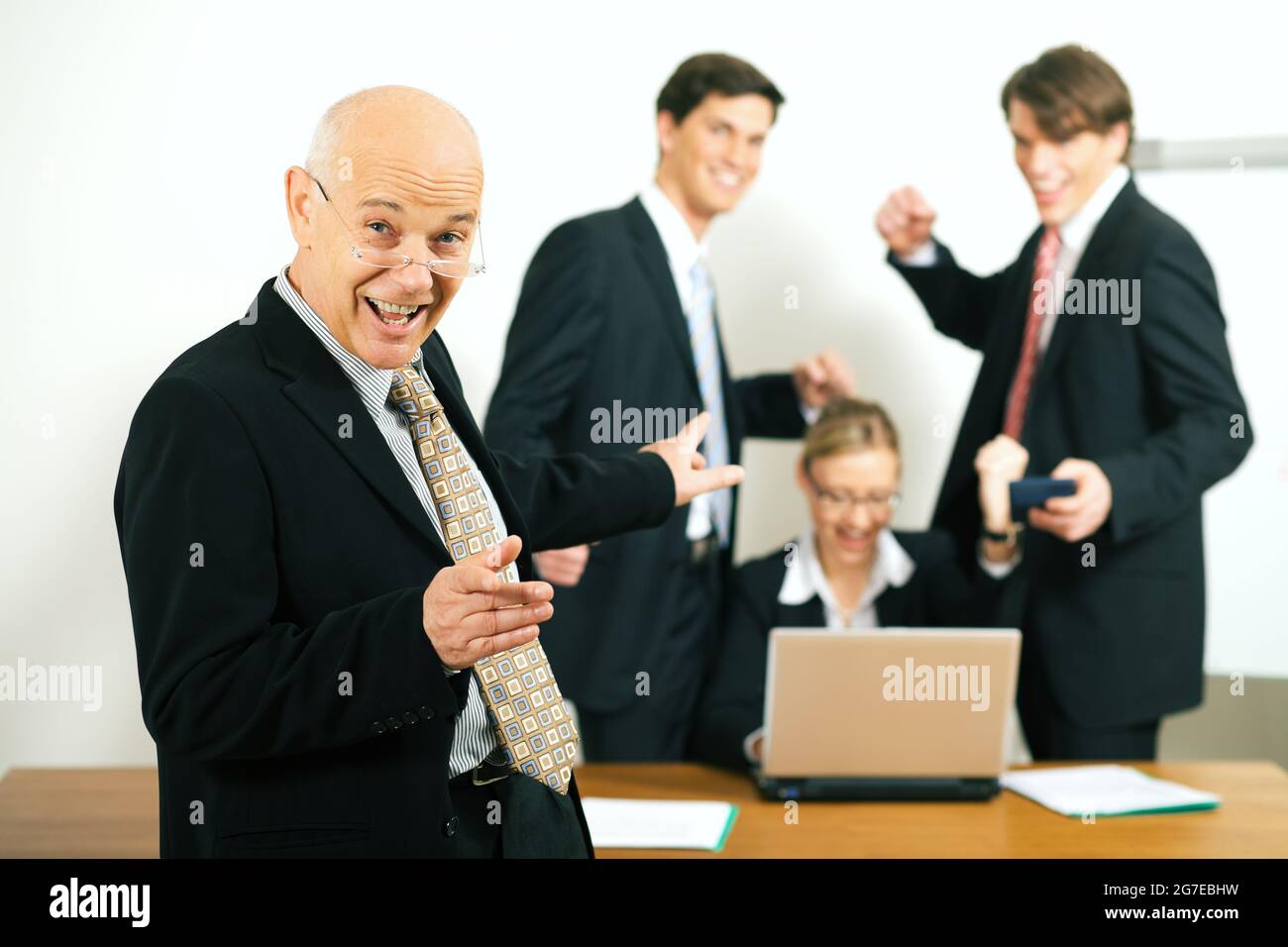 very successful business team with a portrait of the team leader in foreground (selective focus only on the team leader!) Stock Photo