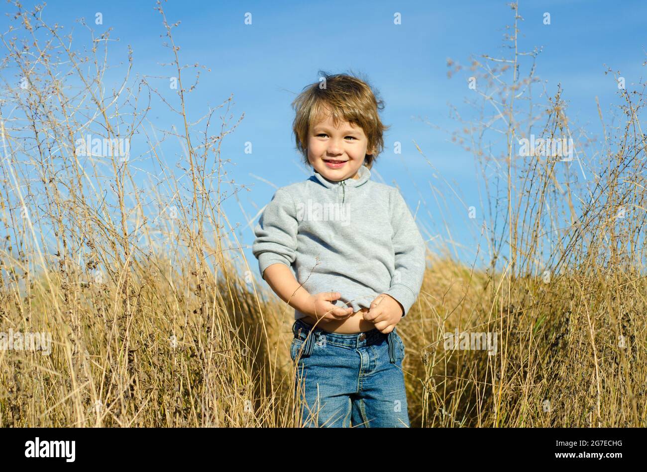 smiling little boy on a rural field Stock Photo