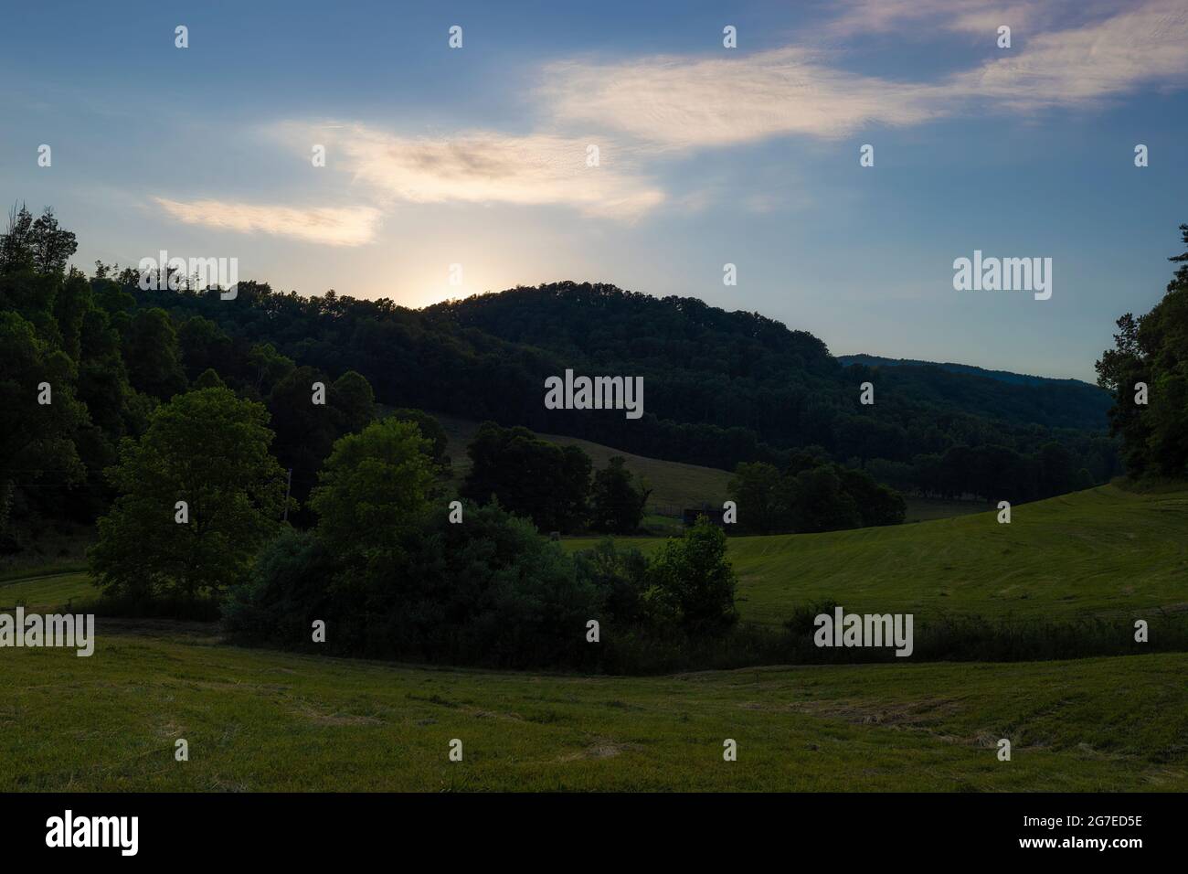Sun slides behind the hills late summer evening in North Eastern Tennessee Stock Photo