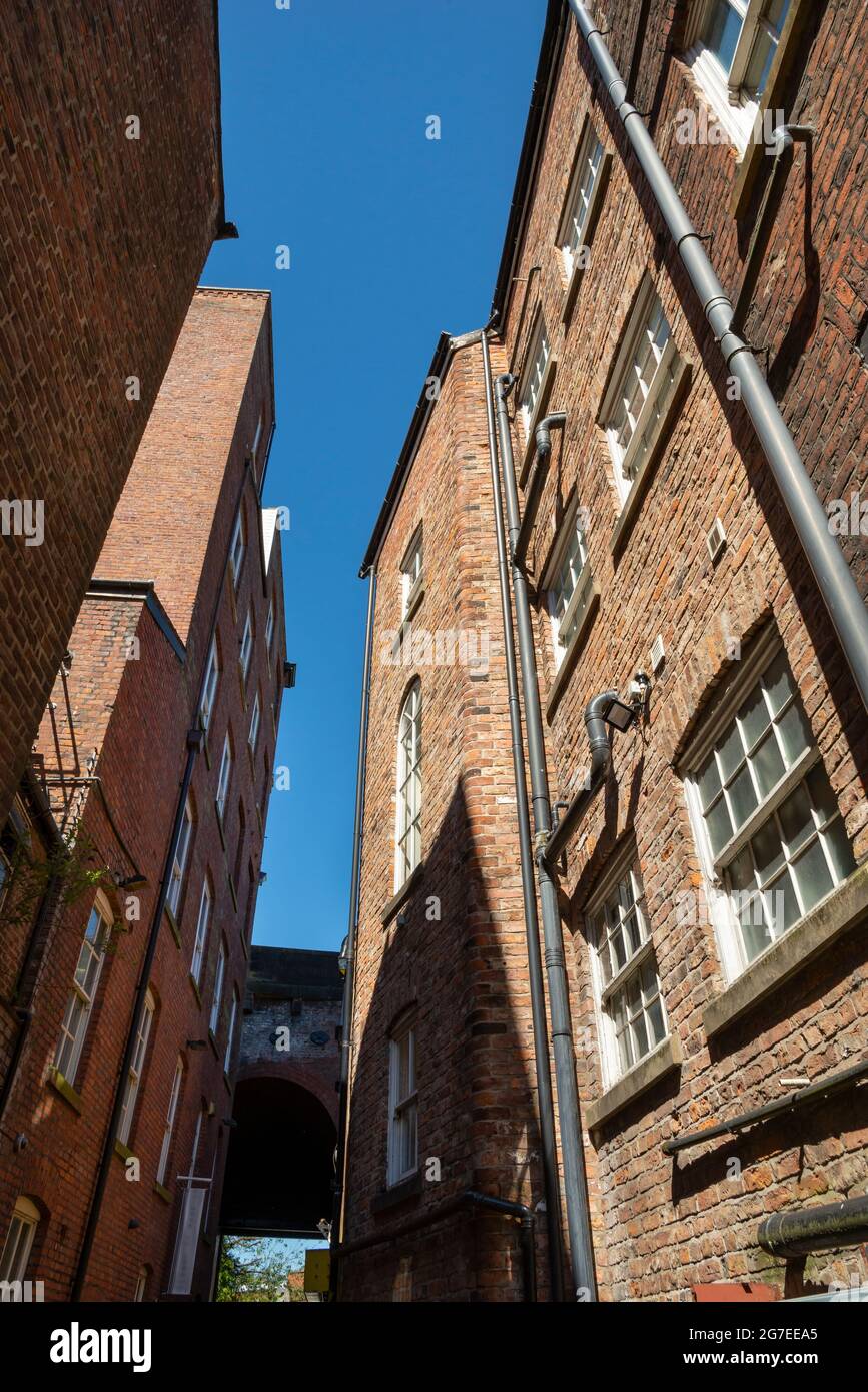 Tall brick buildings off Little Underbank in a historic area of the town of Stockport, Greater Manchester, England. Stock Photo