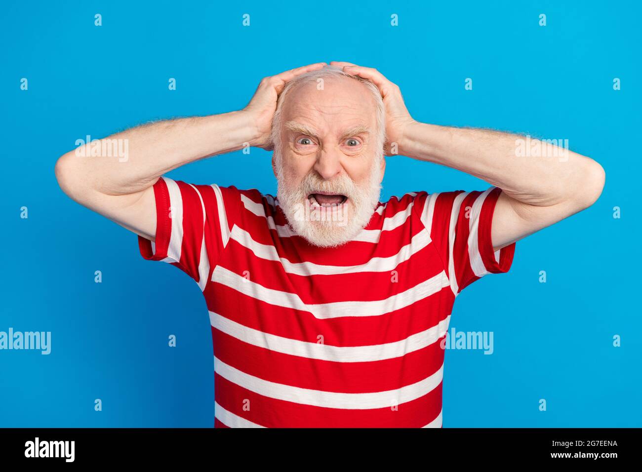 Photo of angry old grey hairdo man hand head wear red t-shirt isolated on bright blue color background Stock Photo