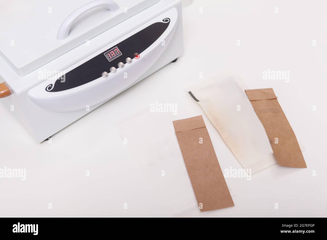 Top view cropped shot of dry heat autoclave machine and paper envelopes