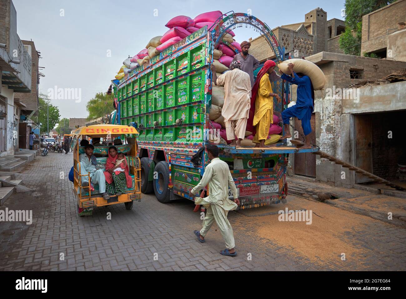 Wheat being loaded in a truck parked at market place in Sindh Pakistan Stock Photo
