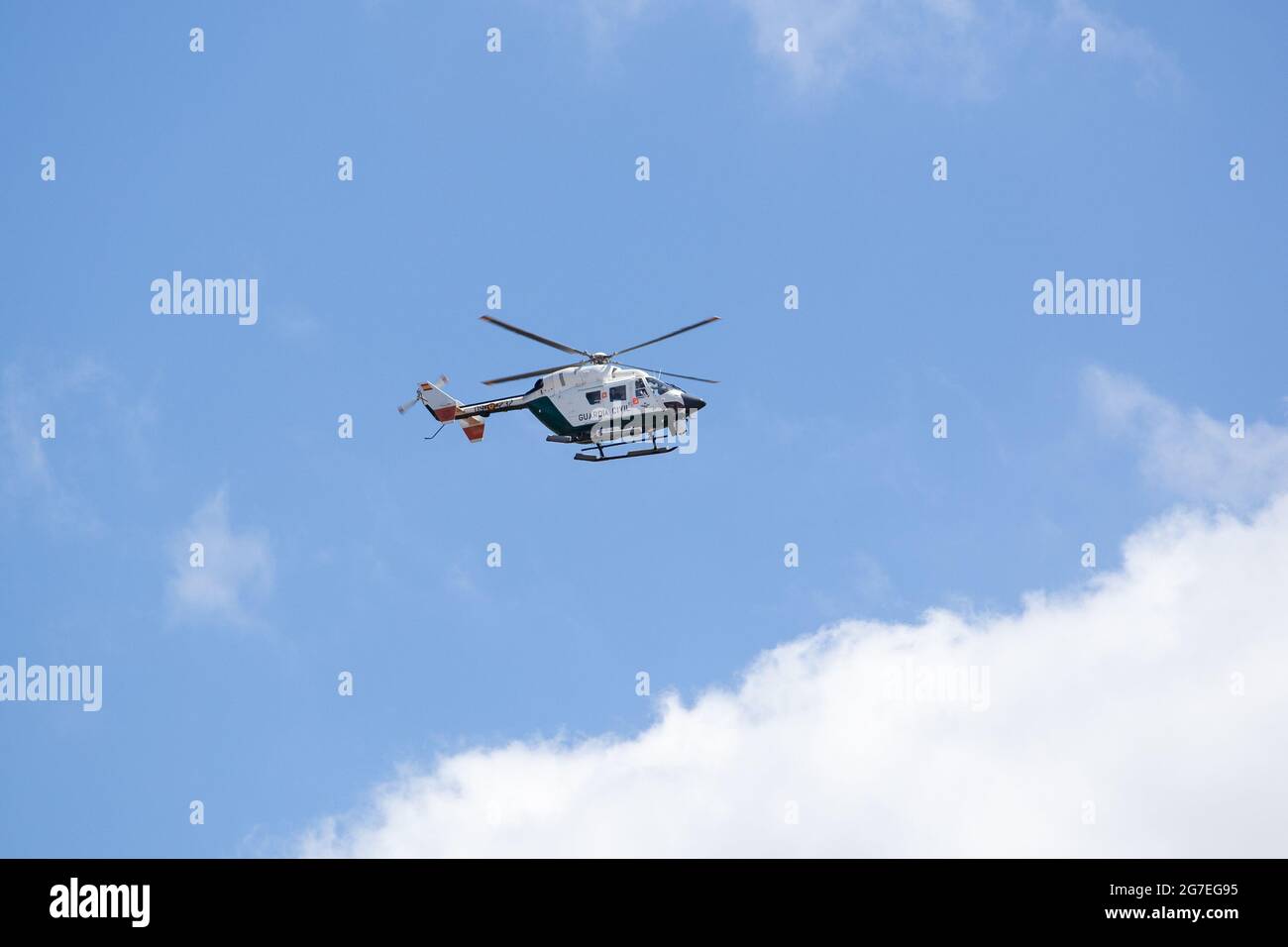 Galicia, Spain; July 8, 2021: Guardia Civil Traffic surveillance helicopter with camera system flying. Traffic surveillance Stock Photo