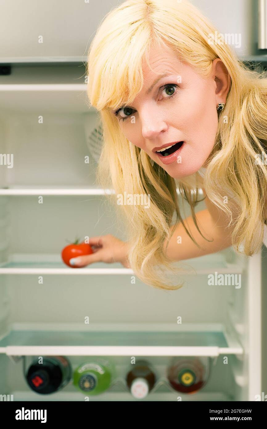 Woman and her fridge spirits and one tomato Stock Photo Alamy