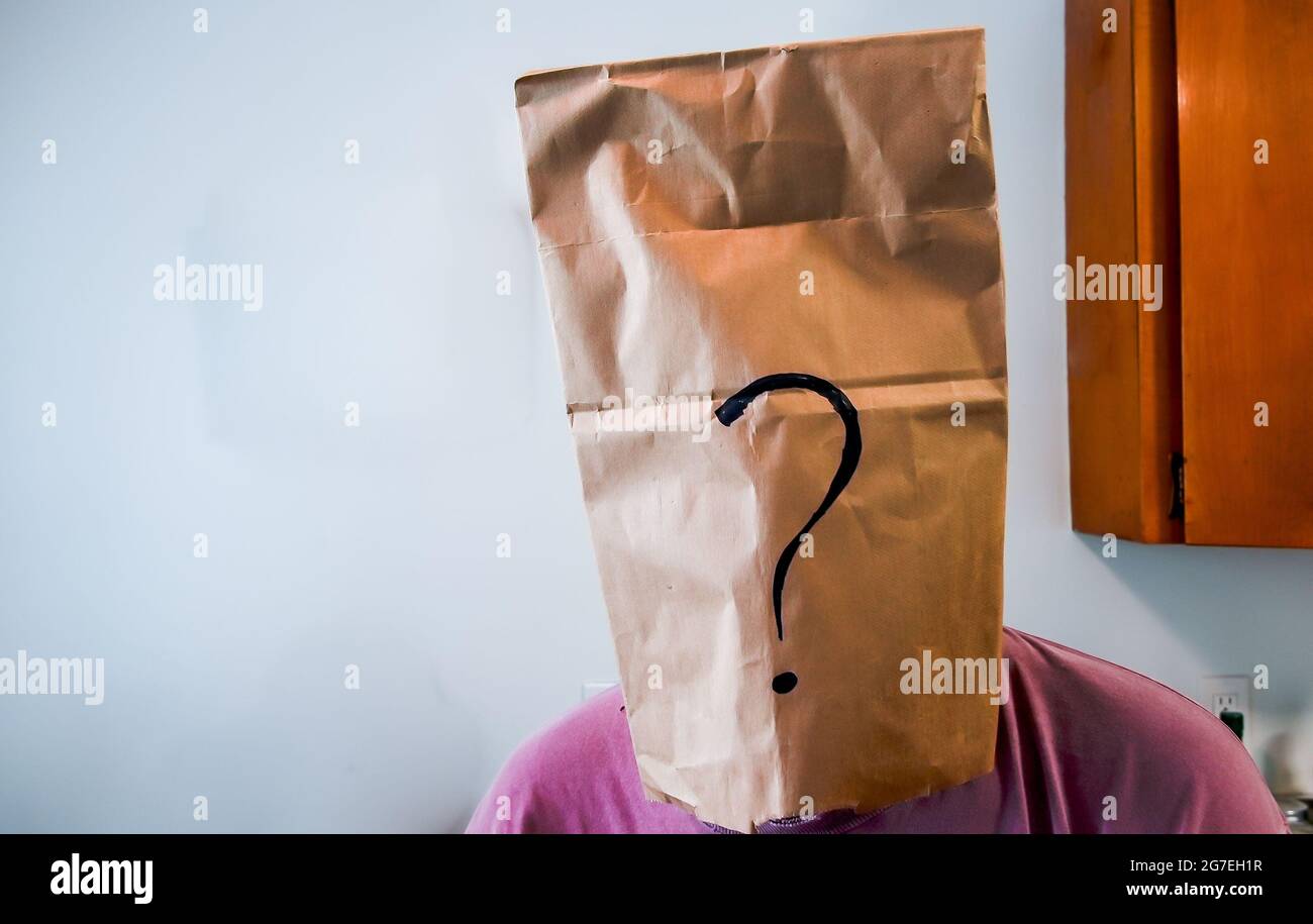 Anonymous person with paper bag with question mark on head Stock Photo