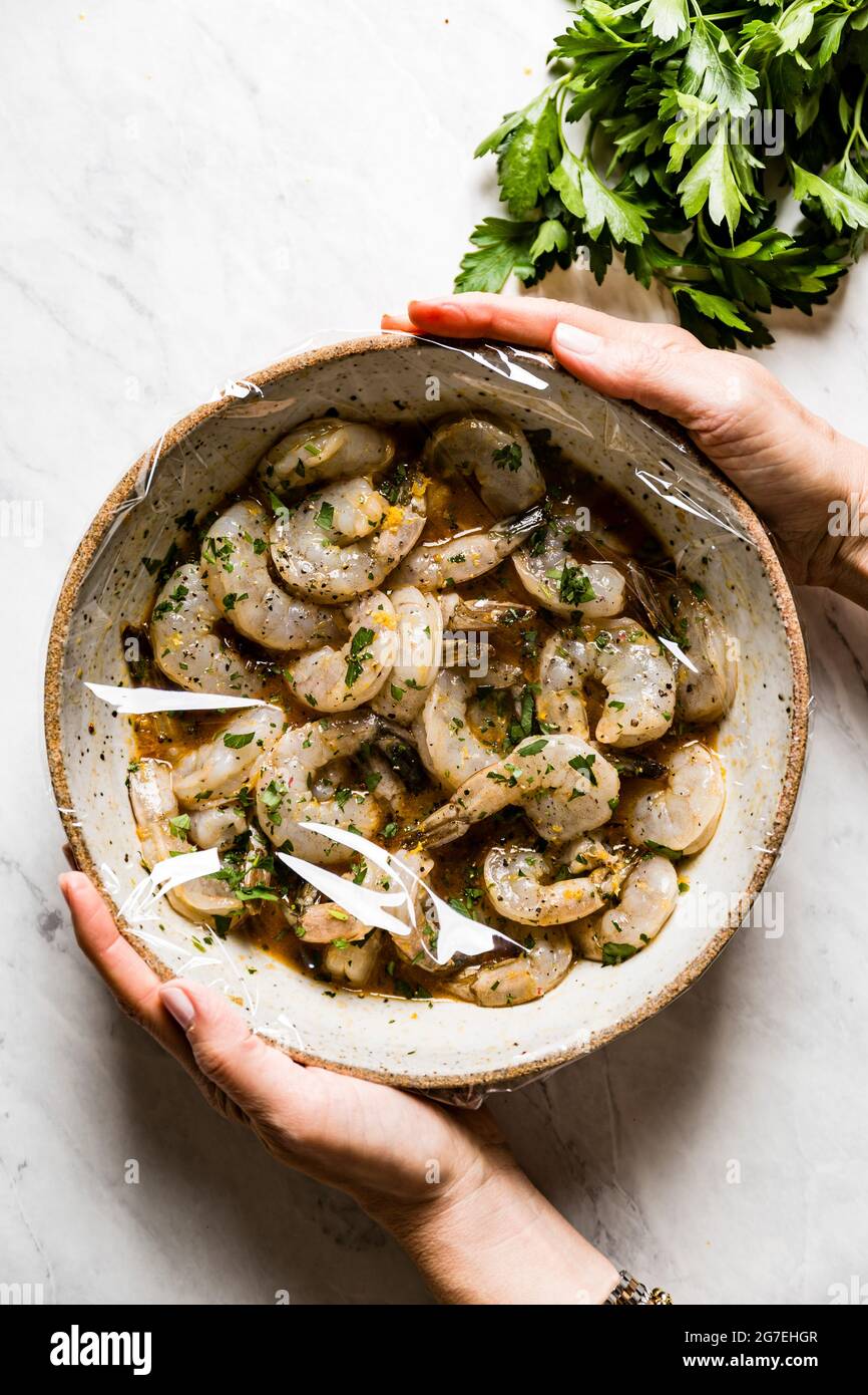 Shrimp in a homemade marinade, on a marble background Stock Photo