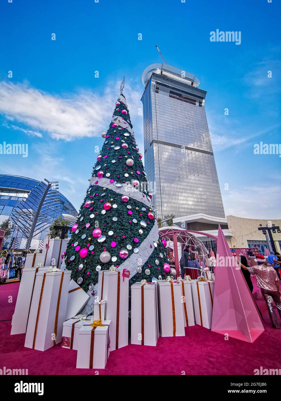 DUBAI, UNITED ARAB EMIRATES - Dec 19, 2020: Palm Tower by Nakheel and a Christmas Tree during Holiday Season Stock Photo