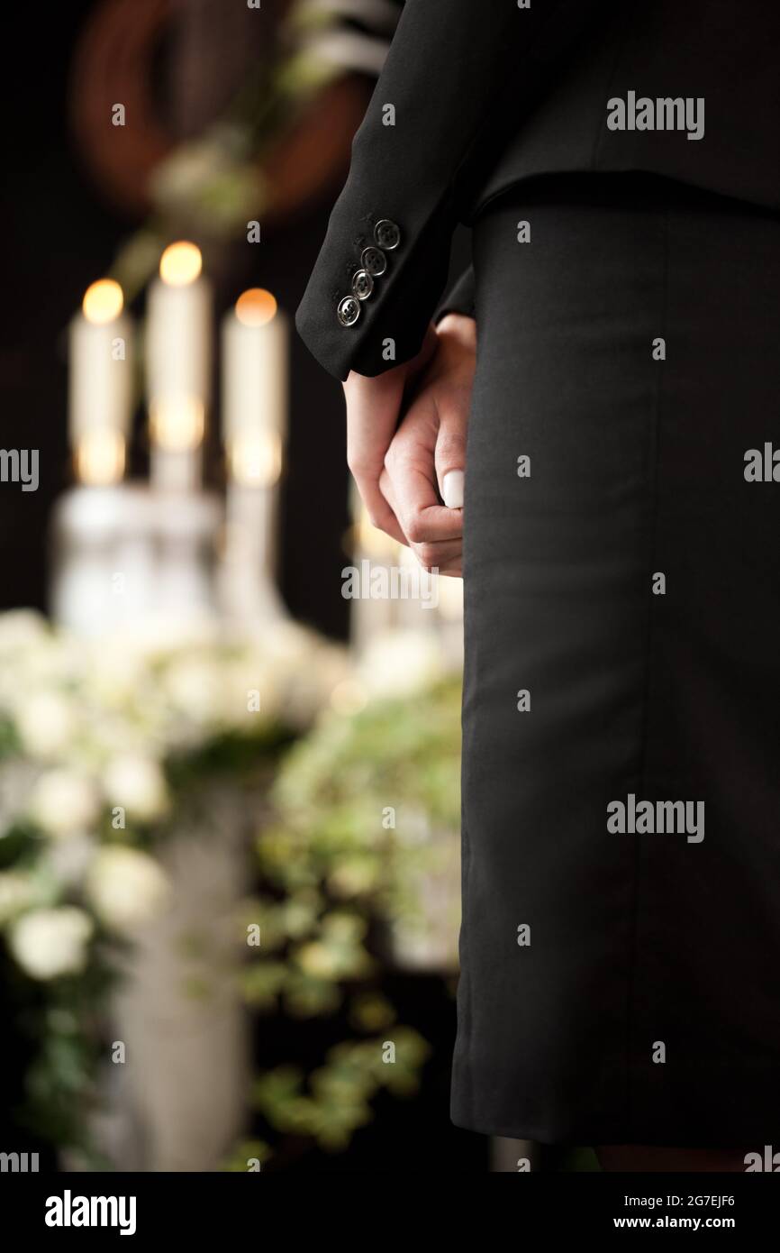 Religion, death and dolor  - woman at urn funeral mourning the death of a loved person Stock Photo