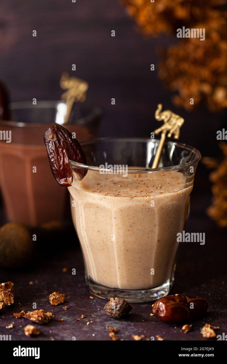 Two healthy date shake milkshakes. One is flavoured with spices and the other with chocolate Stock Photo