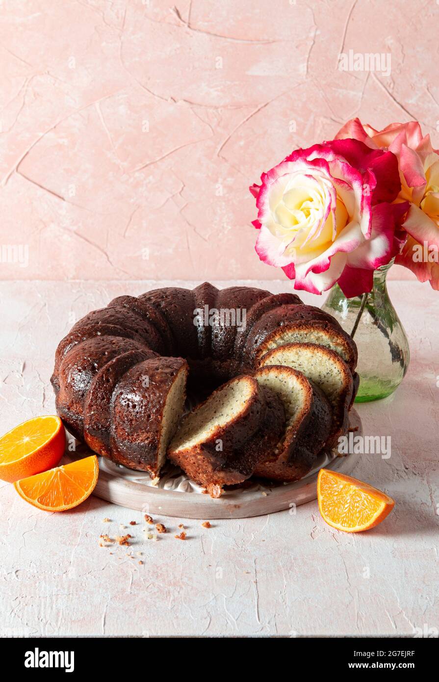 Almond Orange Poppy Seed Bundt Cake with roses Stock Photo Alamy