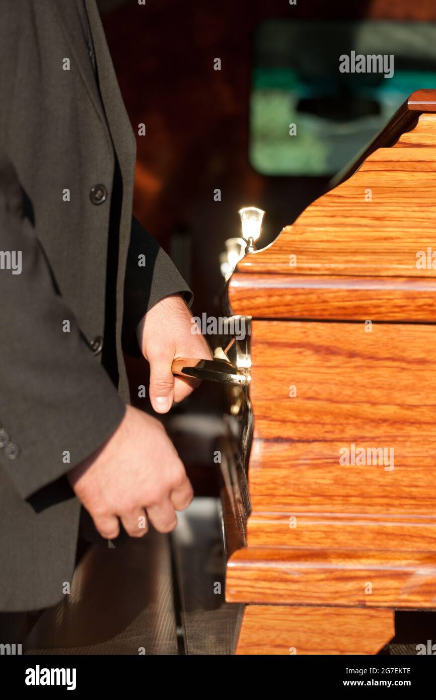 Dolor Funeral with coffin on a cemetery, the casket carried by coffin
