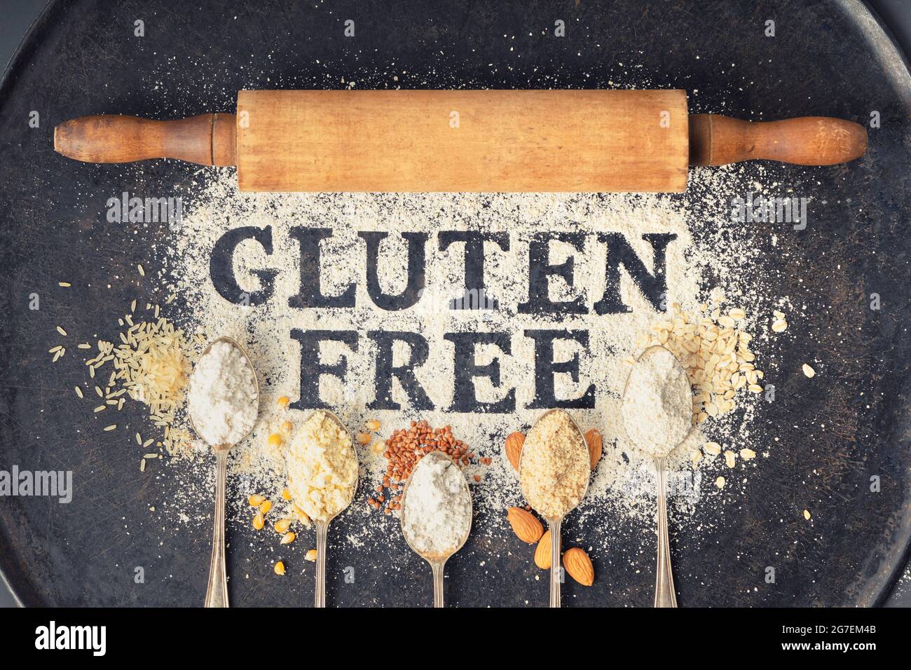 Gluten free written in flour on vintage baking sheet, rolling pin and