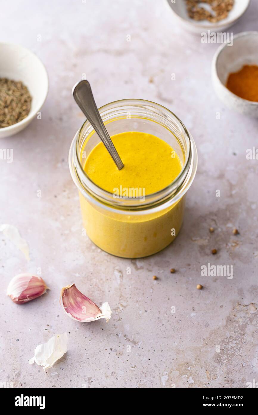 Golden turmeric tahini dressing preparation Stock Photo Alamy