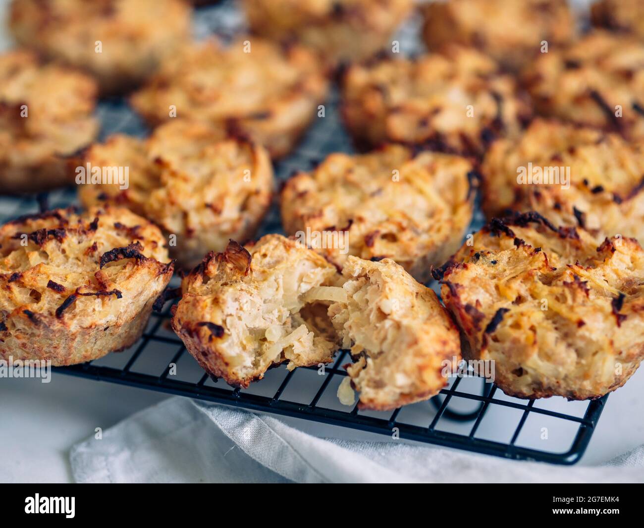 Savory meat muffins on cooling rack. Homemade delicious muffins with chicken, potatoes and eggs without flour and cheese. Paleo diet and lunch to-go m Stock Photo