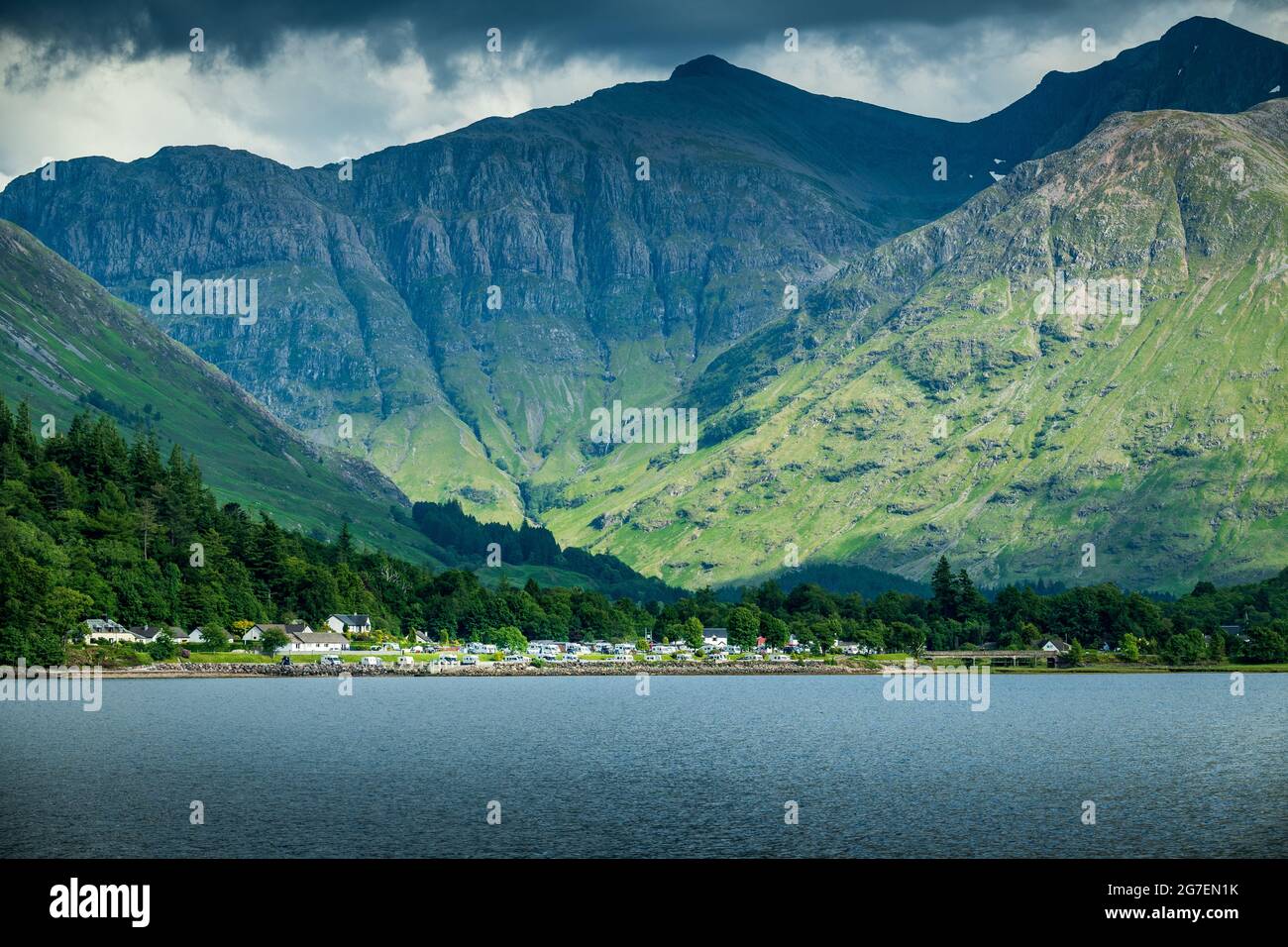 a large body of water with a mountain in the background at Glencoe Stock Photo
