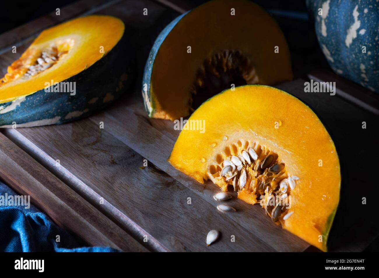 Slices of jap pumpkin on a wooden cutting board. Stock Photo
