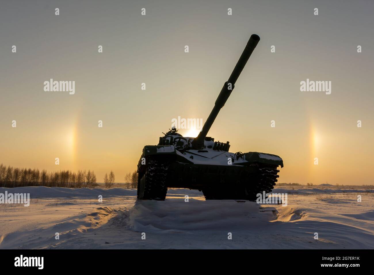 Modern military tank on the background of a solar halo effect. The concept of reducing the world arms race. Stock Photo