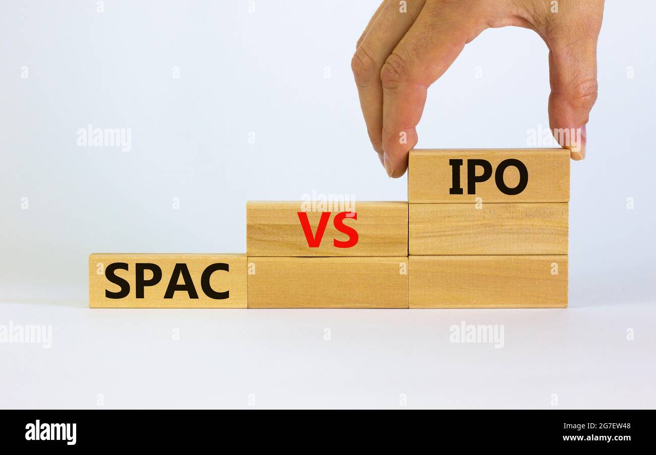 SPAC vs IPO symbol. Blocks with words 'SPAC, special purpose acquisition company' and 'IPO, initial public offering' on white background. Businessman Stock Photo