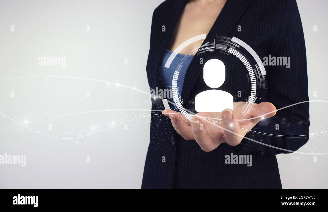 Human Resources HR management concept. Hand hold digital hologram human on grey background, business organization and staff hierarchy Stock Photo