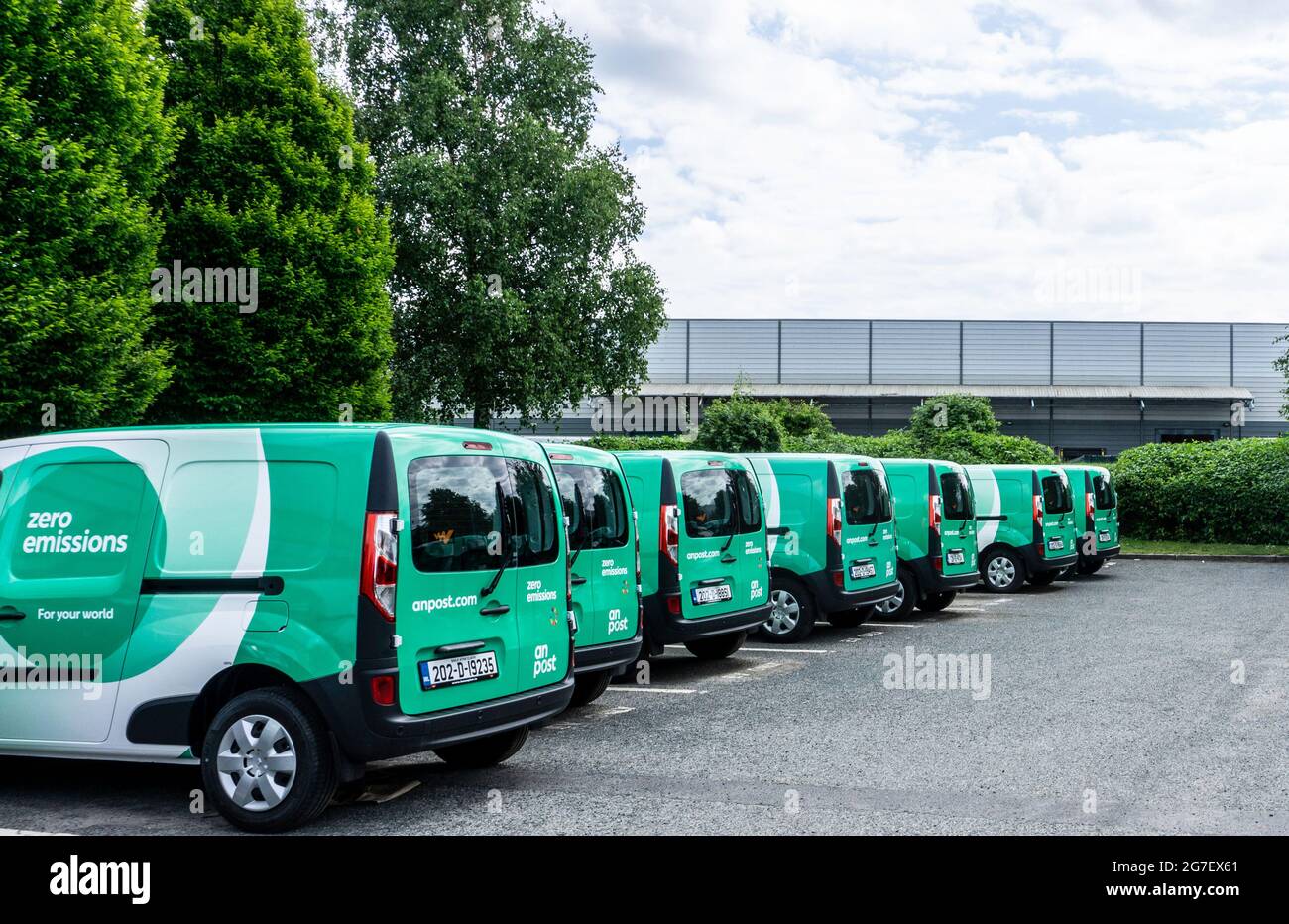 A row of electric, zero emission, delivery vans at an An Post Depot in Dublin, Ireland. Stock Photo