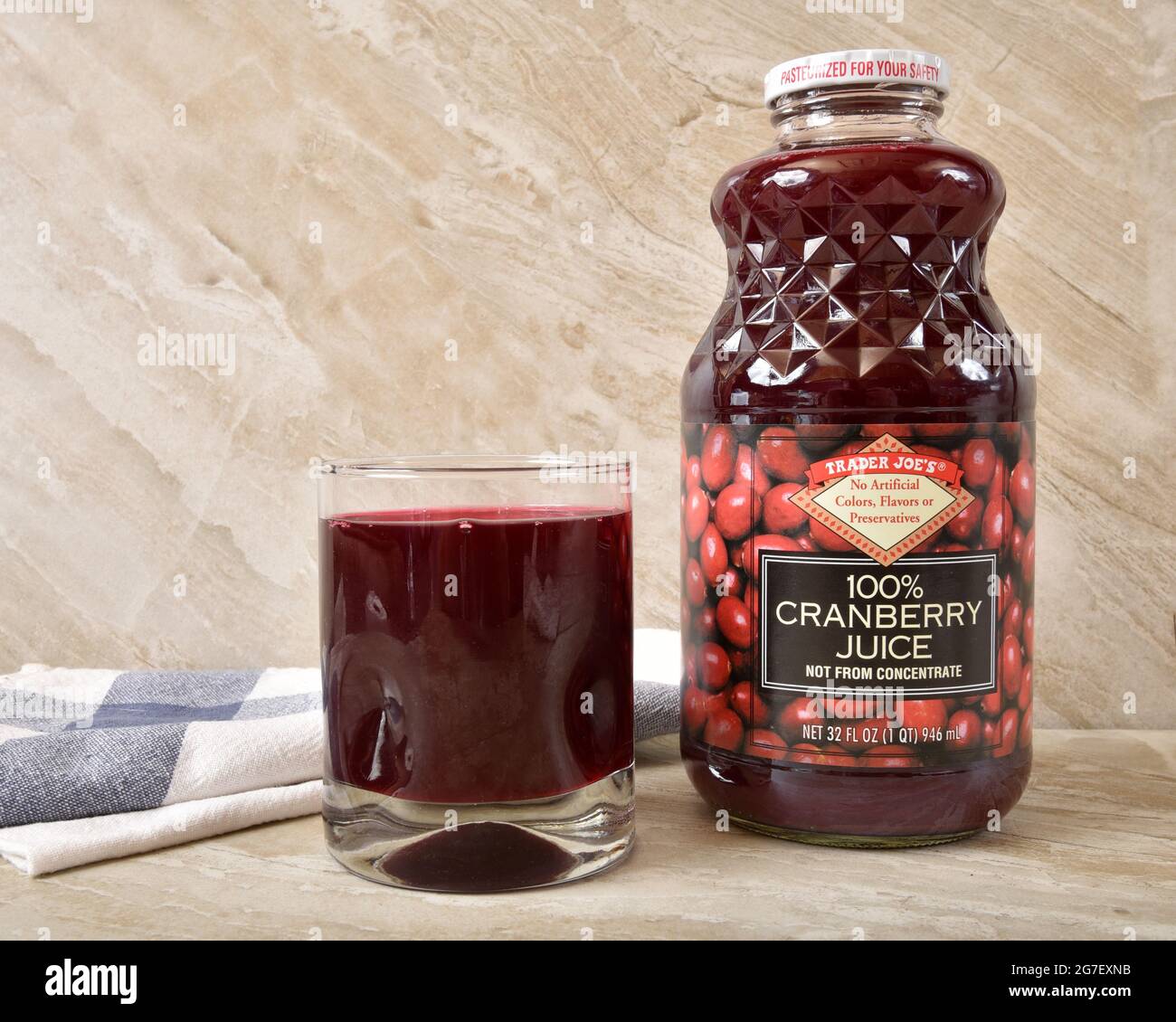 A bottle of Trader Joe’s Cranberry Juice and a glass of juice