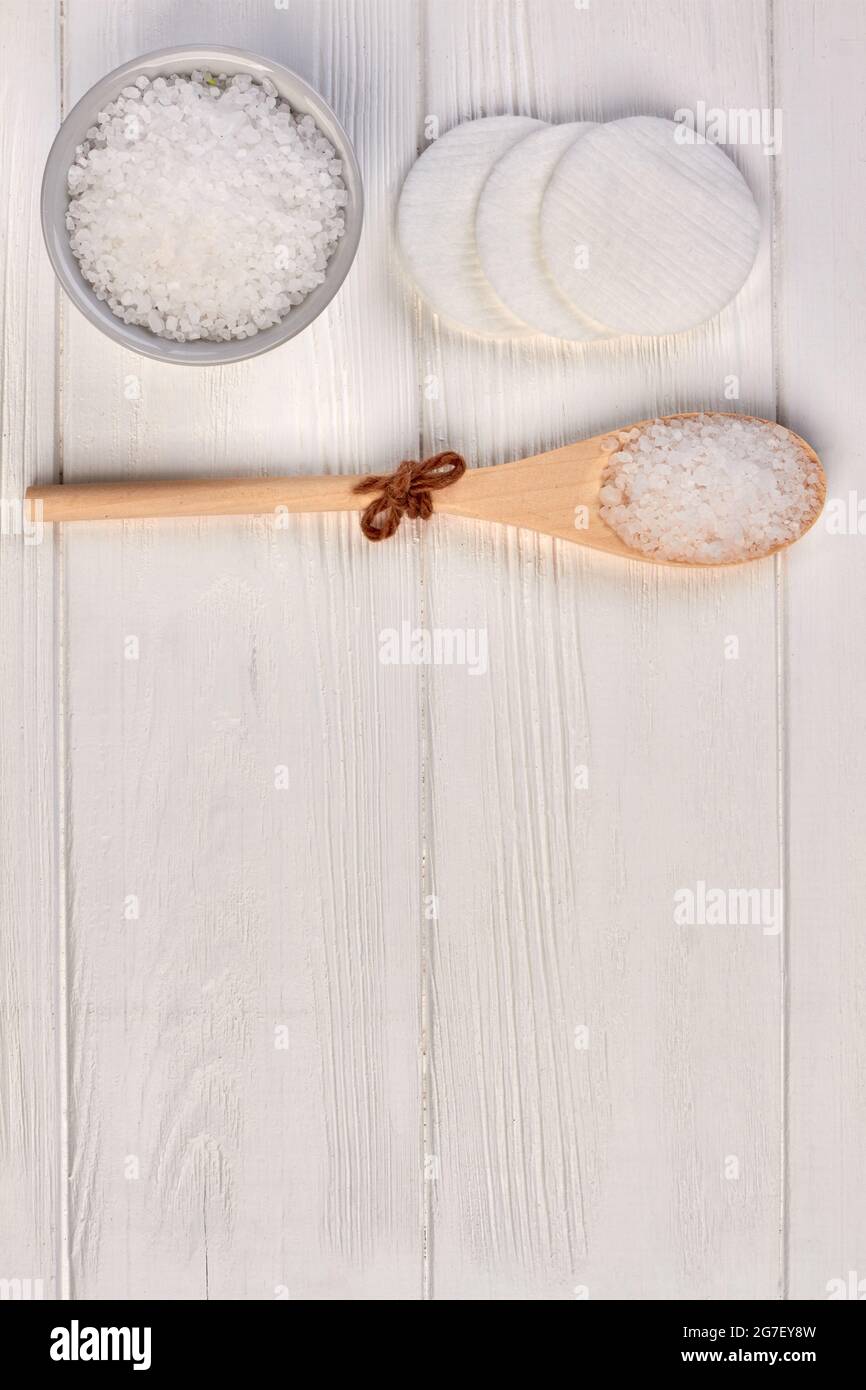 Wooden spoon with bath salt for spa and cotton pads. Stock Photo