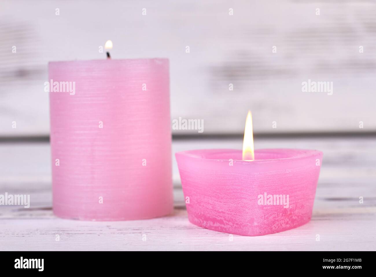 Pillar wax candle burning on white background Stock Photo - Alamy