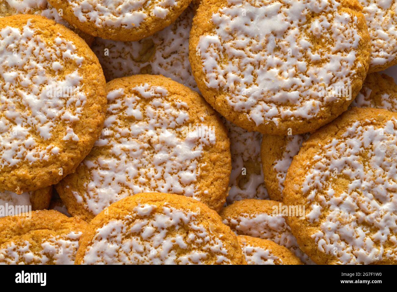 Pile of Frosted Oatmeal Cookies Background Texture. Stock Photo