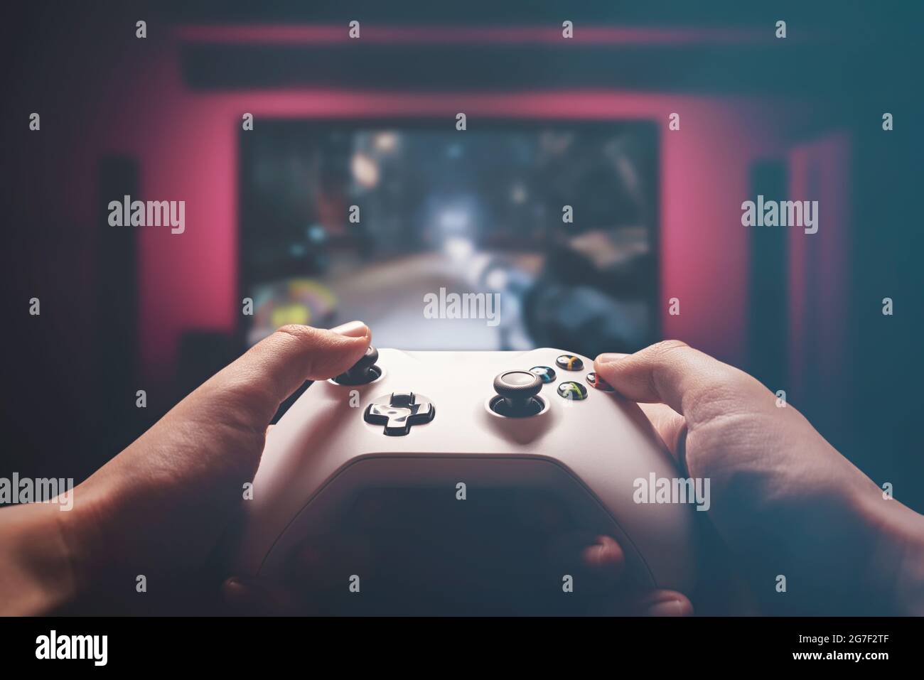 Man is playing on the console. Man holding gamepad and playing shooter game  Stock Photo - Alamy