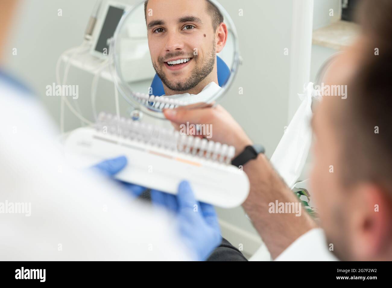 Handsome young man in stomatology clinic. Healthy teeth whitening. Stock Photo