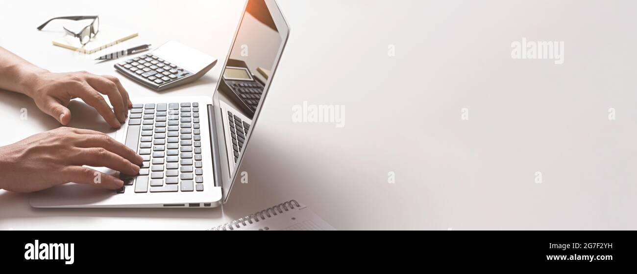 Man using laptop, accountant working in the office. Image background with copy space Stock Photo