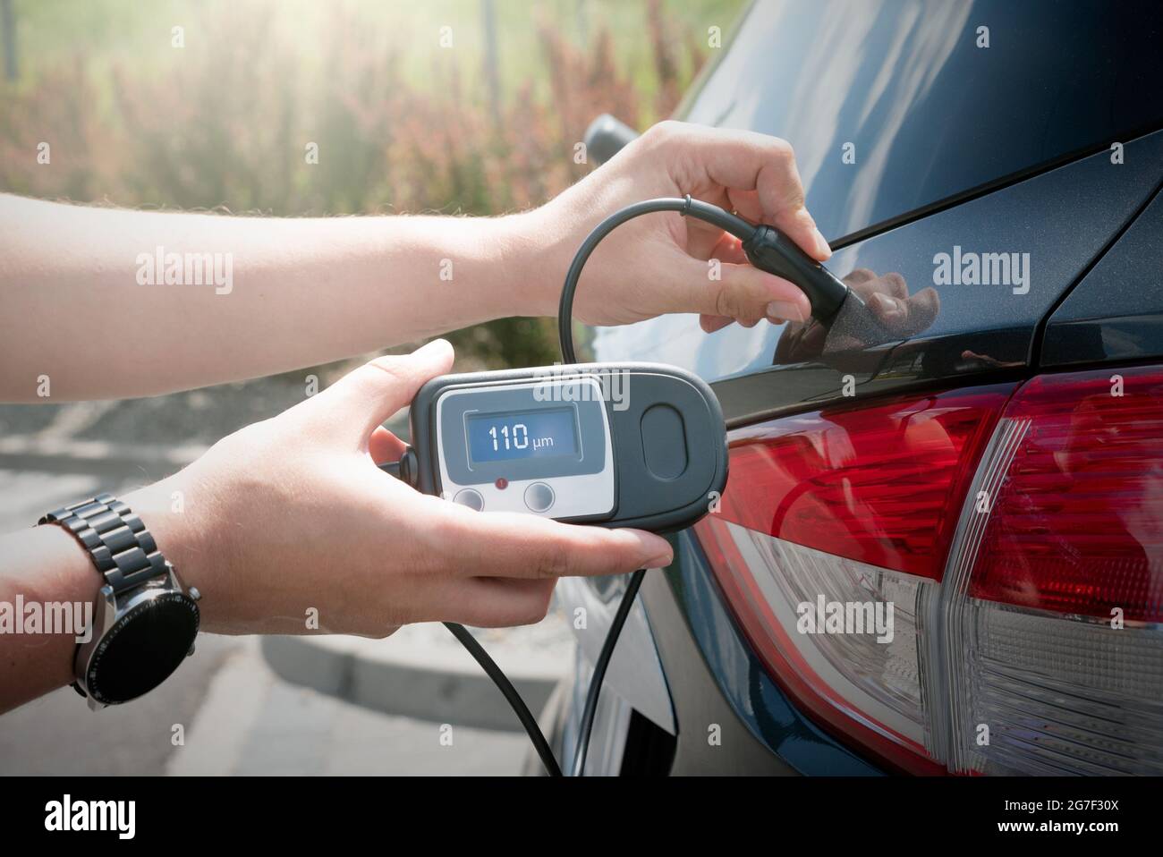 Measuring thickness of the car paint coating with paint thickness gauge
