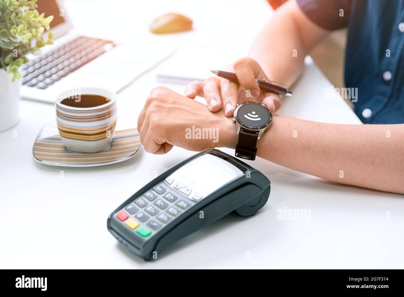 Man pays by a smart watch in a cafe restaruant. Contactless, convenient form of payment Stock Photo