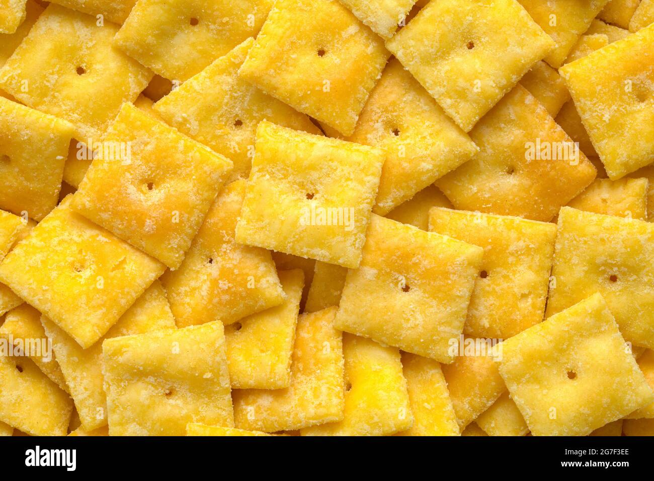 Pile of Cheese Square Crackers Background Texture. Stock Photo