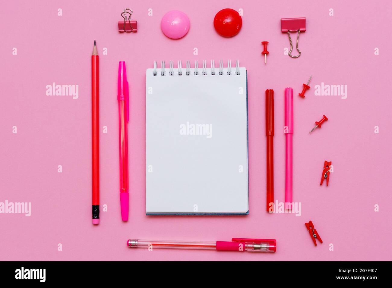 Stationery in pastel pink shades. On a pink background, flat lay ...