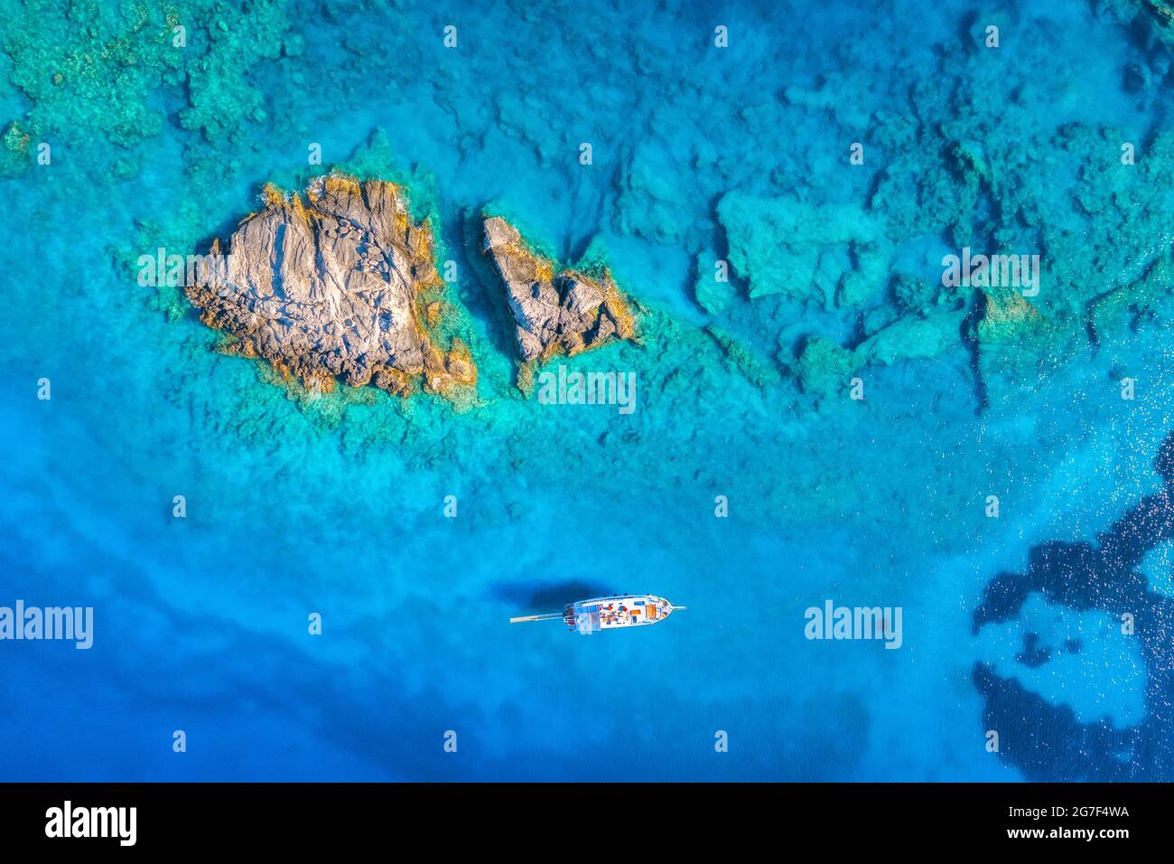 Aerial view of beautiful yacht on the sea and rocks at sunset Stock ...