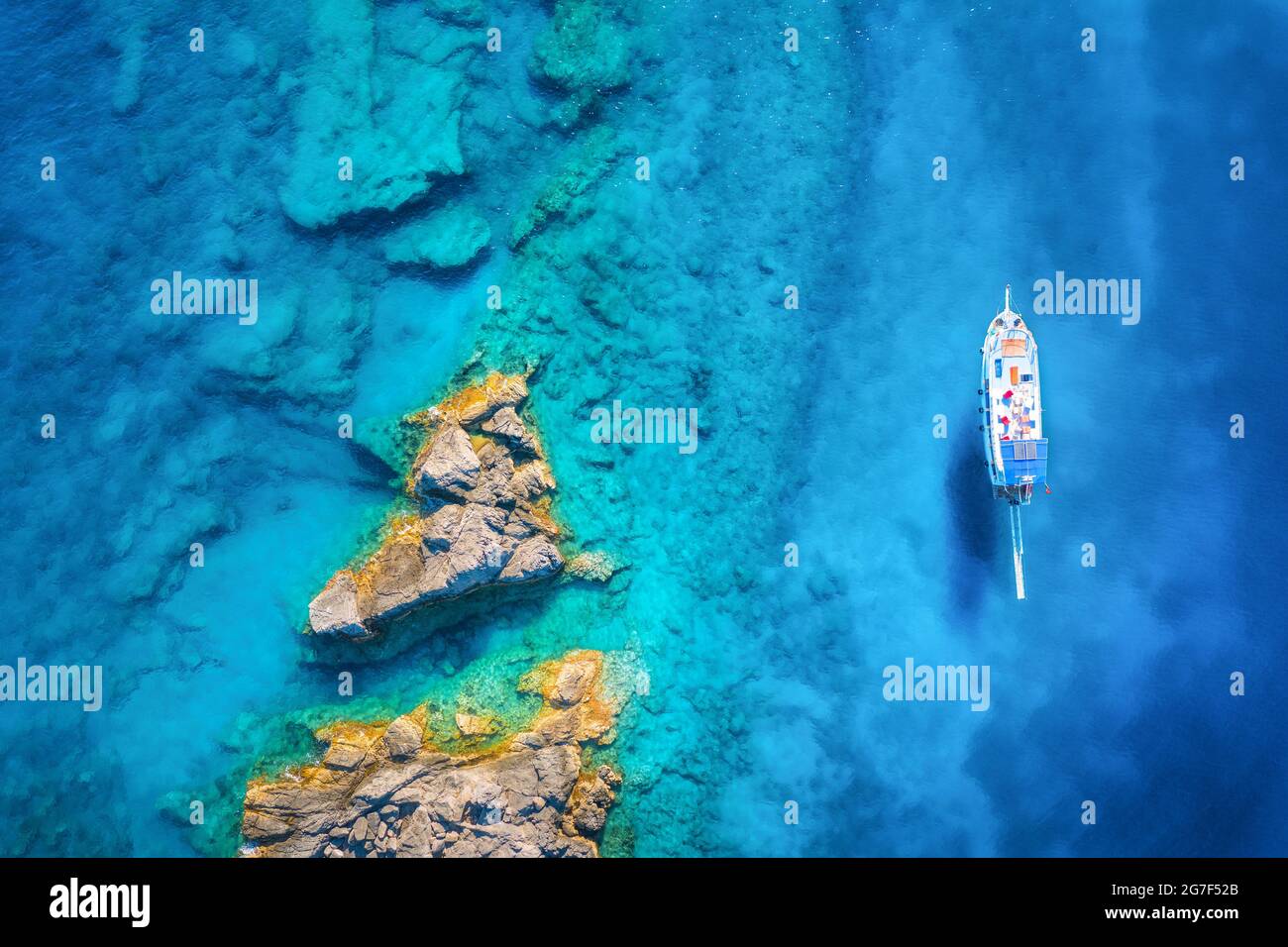 Aerial view of beautiful yacht on the sea and rocks at sunny day Stock ...