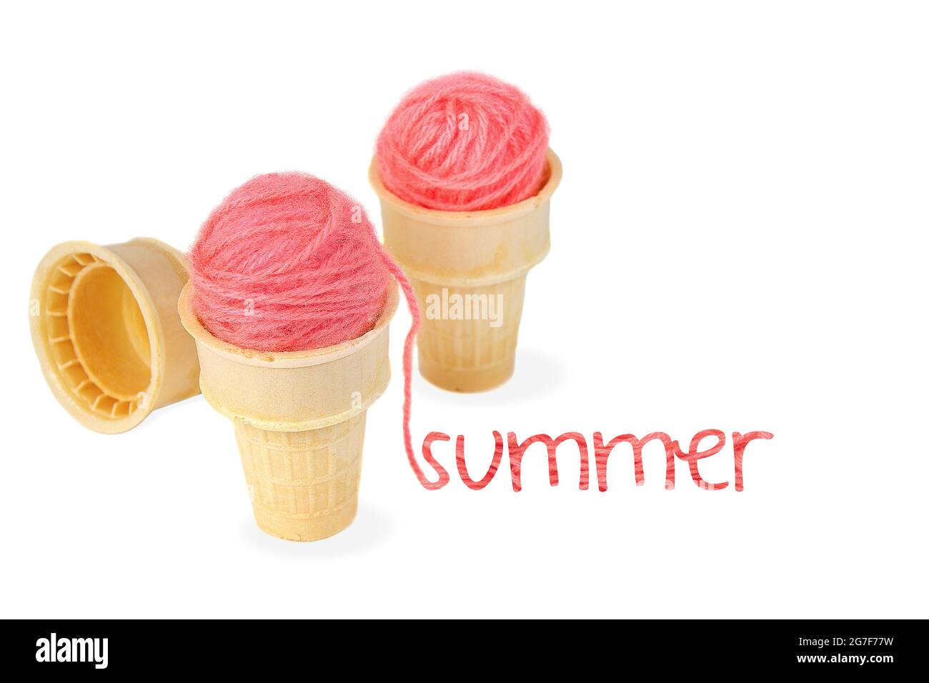 Pink yarn balls in ice cream cone with summer text isolated on white Stock Photo