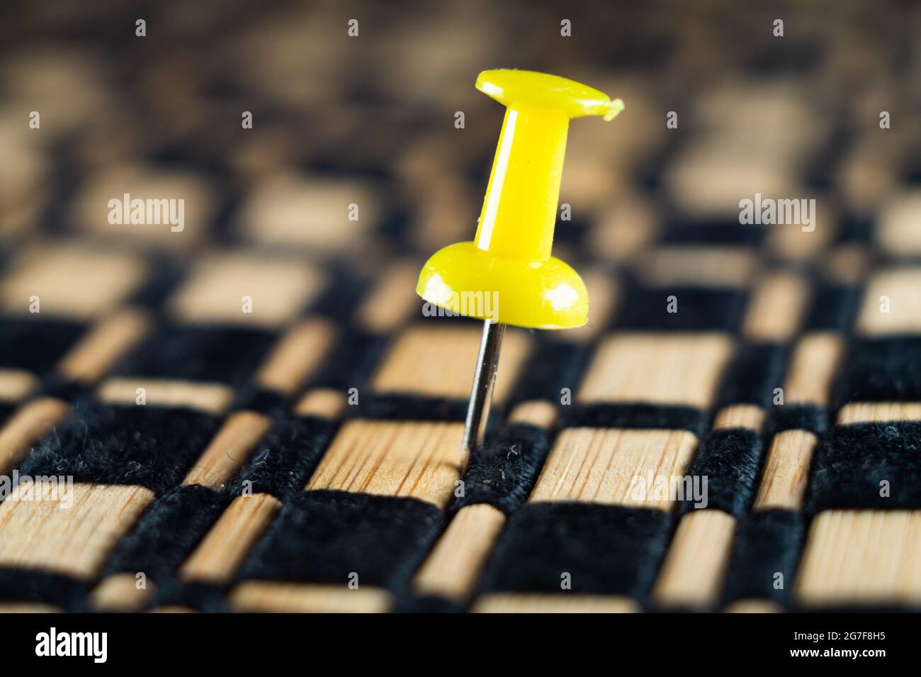 Closeup photo of a yellow push pin fixed in a surface Stock Photo Alamy