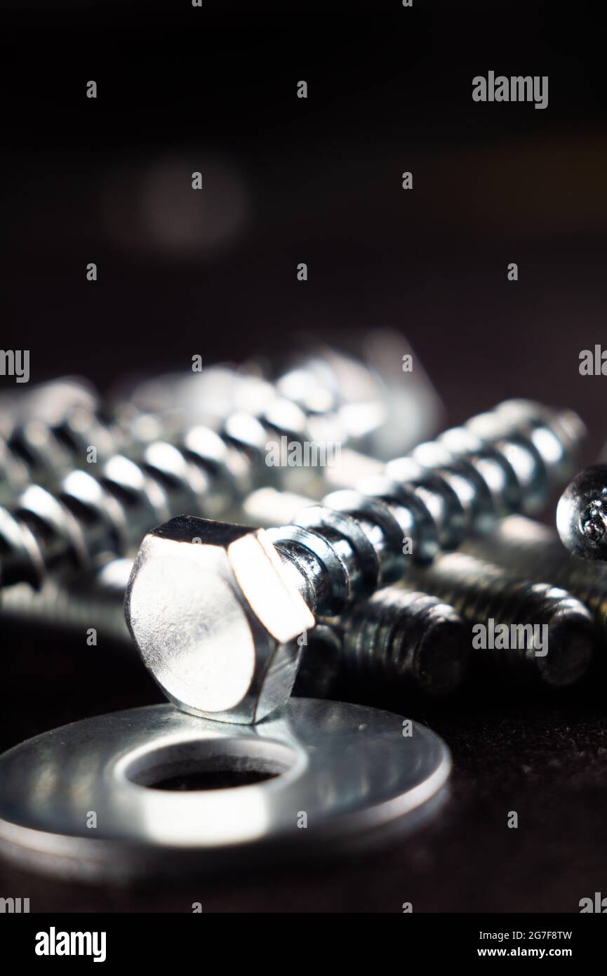 Close-up photo of a set of fasteners on a black surface Stock Photo - Alamy