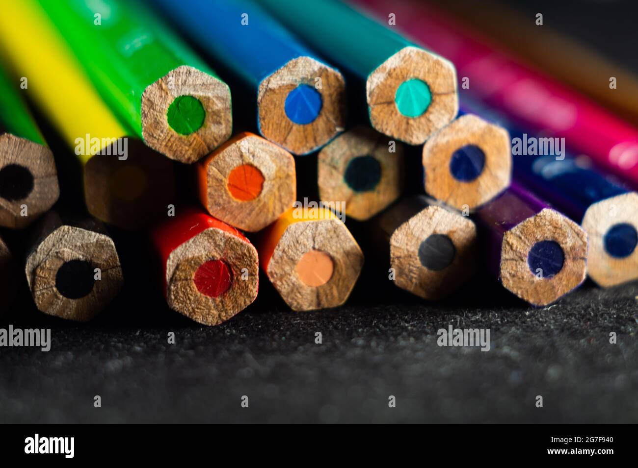 Beautiful shallow focus photo of a set of pencils on a black surface Stock Photo
