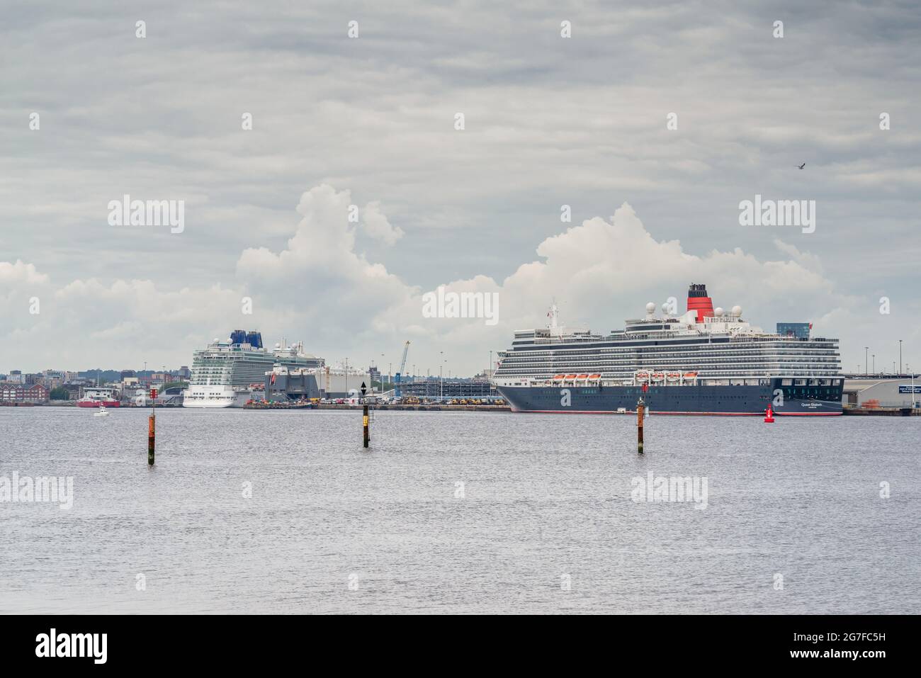 The Cunard Queen Elizabeth and Britannia cruise ships docked in the Port of Southampton, seen from Hythe marina, Southampton, England, UK Stock Photo