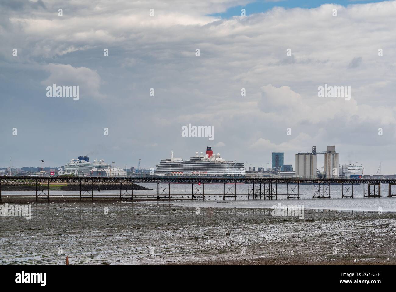 The Cunard Queen Elizabeth and Britannia cruise ships docked in the Port of Southampton, with Hythe Pier in the foreground, Southampton, England, UK Stock Photo