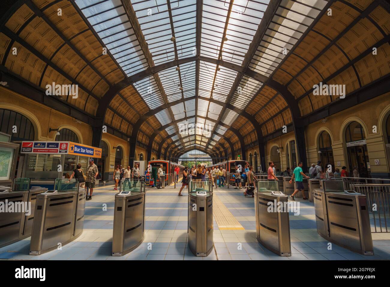 PIRAEUS, ATTICA, GREECE- JULY 2017. Inside the historical train (& metro) station at the port of Piraeus. Urban scenery with traffic of travelers and Stock Photo