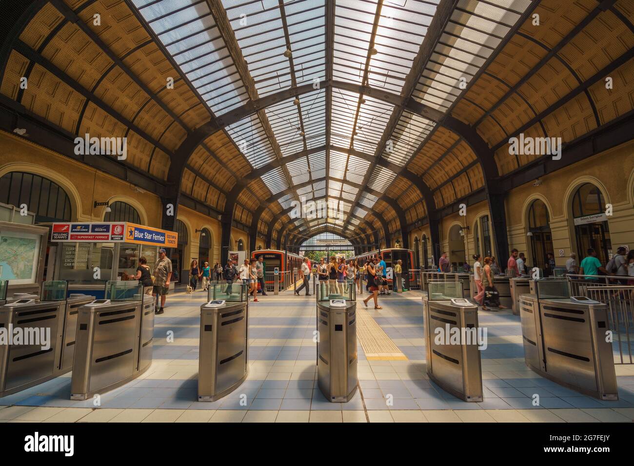 PIRAEUS, ATTICA, GREECE- JULY 2017. Inside the historical train (& metro) station at the port of Piraeus. Urban scenery with traffic of travelers and Stock Photo